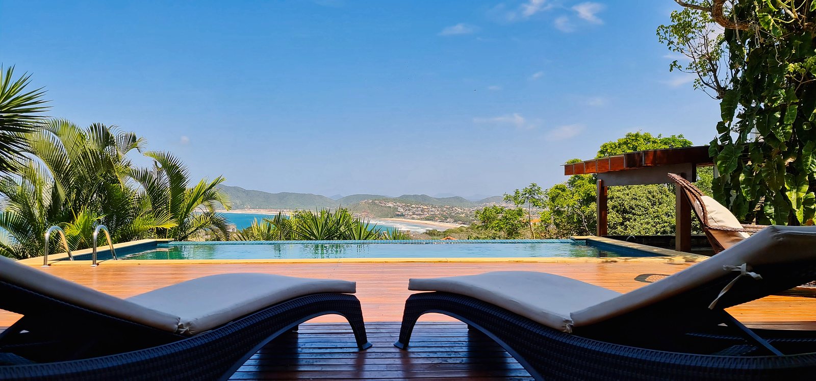 The deck at Casalita at golden hour, loungers facing the bay