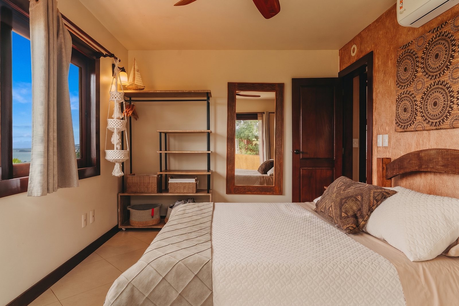 Sunset Suite bed with the tiled headboard art and the sliding door